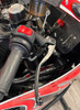 Magura HC1 Radial Master Cylinder Brake Kit, close-up view of the motorcycle handlebar showcasing the black and red brake master cylinder, hydraulic clutch lever, and handlebar grip with control switches.