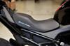 Brocks Performance Custom Corbin Seat for BMW S1000RR 2020-2025 and S1000R 2020-2024, close-up view of the sleek black seat with textured surface and illuminated logo.