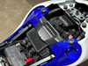 Schnitz Racing MaxxECU Sport Plug and Play Kit Suzuki Hayabusa (22-25), close-up view of the electronic control unit installed in the motorcycle's engine compartment with various wires and components visible. Schnitz Racing MaxxECU Sport Plug and Play Kit Suzuki Hayabusa (22-25), close-up view of the electronic control unit installed in the motorcycle's engine compartment with various wires and components visible.