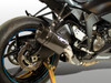 M4 Performance Exhausts M4 Tech1 Carbon Fiber Slip On Exhaust for Kawasaki ZX-6R (09-25), close-up of motorcycle's rear with carbon fiber muffler, rear wheel, and chassis details.