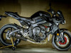 M4 Performance Exhausts M4 Carbon Fiber X-Model Slip On Exhaust Yamaha FZ-10/MT-10 (17-24), black sport motorcycle with a carbon fiber exhaust and advanced aerodynamics displayed in a garage setting.