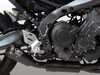 M4 Performance Exhausts M4 Black Exhaust System Yamaha MT-09/XSR900 (21-25), close-up view of the motorcycle's engine and exhaust system with the black exhaust pipe and muffler.
