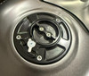 Vortex Gas Caps, close-up image of a black and silver vortex gas cap with intricate design and branding.