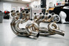 HTP Performance HTP Pigtail Exhaust System for Suzuki Hayabusa (99-26), stainless steel motorcycle exhaust pipes on workshop floor. HTP Performance HTP Pigtail Exhaust System for Suzuki Hayabusa (99-26), stainless steel motorcycle exhaust pipes on workshop floor.