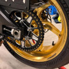 Vortex Motorcycle Parts Vortex V4 Lightweight Rear Sprocket, close-up of the gold motorcycle rear wheel and black sprocket with gold accents.