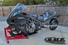 DME Racing Motorcycle Parts DME Zoomie Exhaust System, close-up of the high-performance motorcycle with a sleek black carbon fiber body, custom exhaust system, and aerodynamic design.