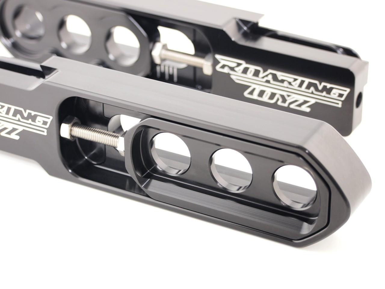 Roaring Toyz Bolt-On Swingarm Extensions for Kawasaki ZX14R, black anodized motorcycle parts with circular cutouts and mounting hardware. Roaring Toyz Bolt-On Swingarm Extensions for Kawasaki ZX14R, black anodized motorcycle parts with circular cutouts and mounting hardware.