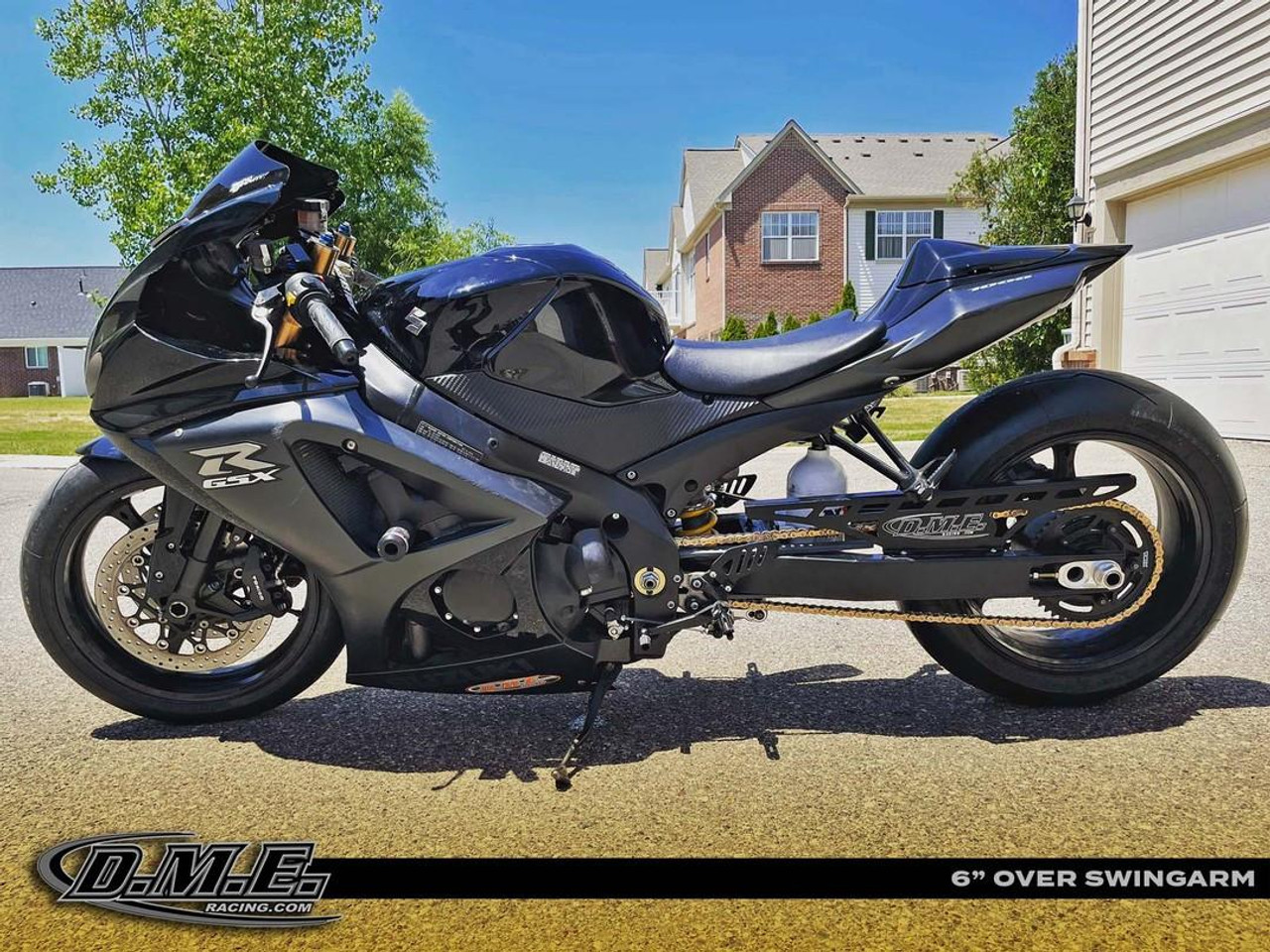 DME Aluminum Swingarm Kawasaki ZX10R (06-07), bicycle-style aftermarket swingarm installed on a sport motorcycle parked outdoors on a sunny day.