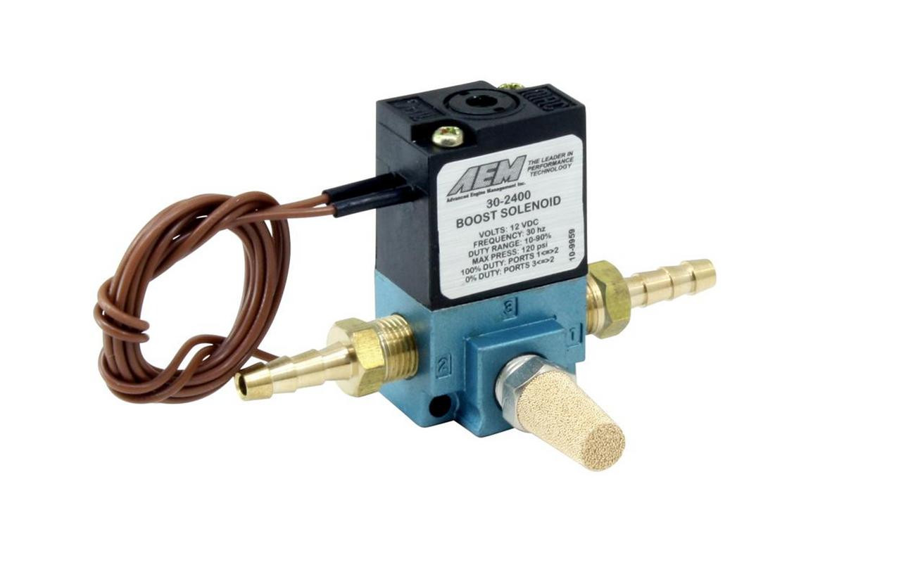 AEM Boost Control Solenoid, a compact automotive engine boost pressure control device with brass fittings and electrical wiring connection.