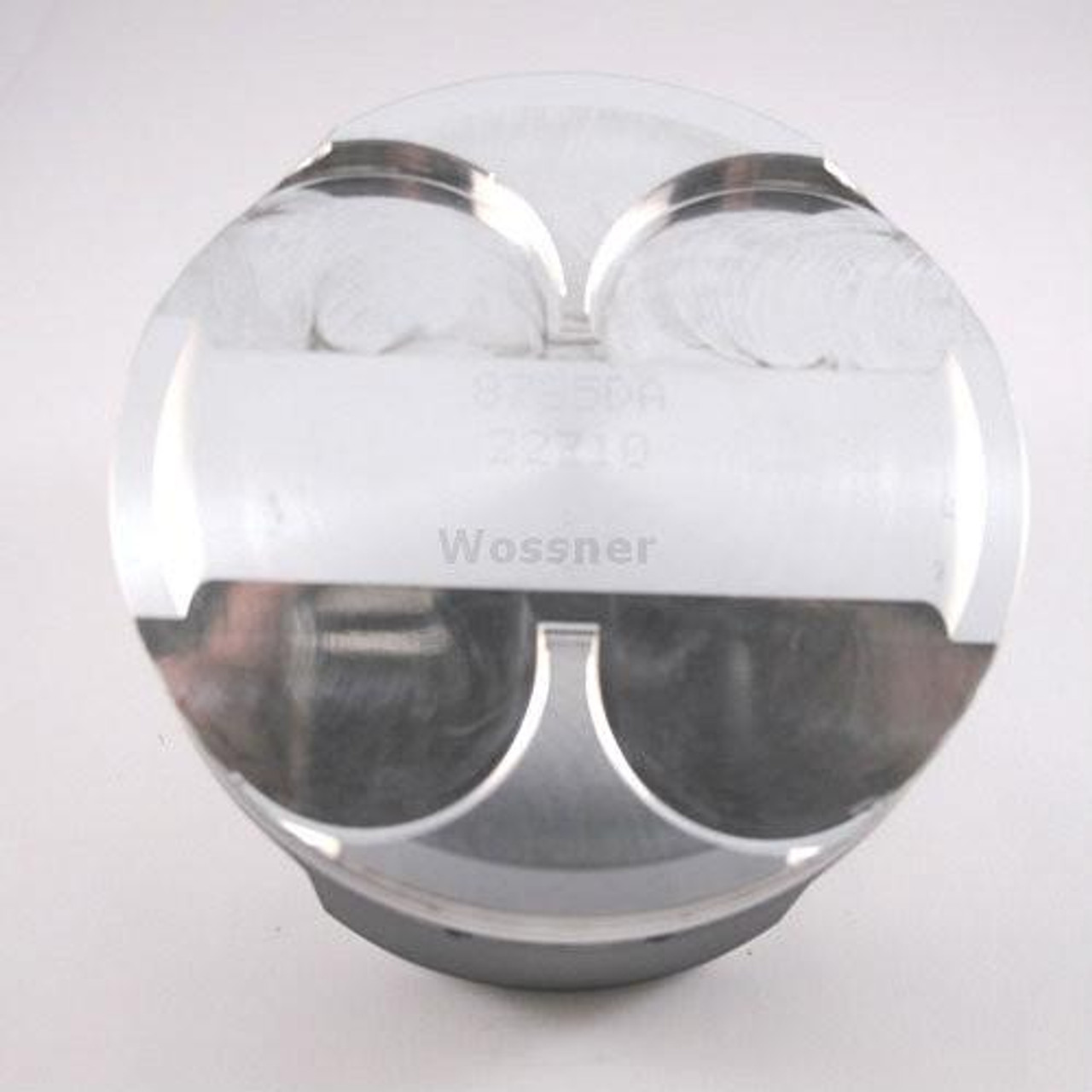 Wossner Piston Kit Kawasaki ZX14R (06-26), close-up of a silver piston with engraved details, showcasing the piston top and side view.