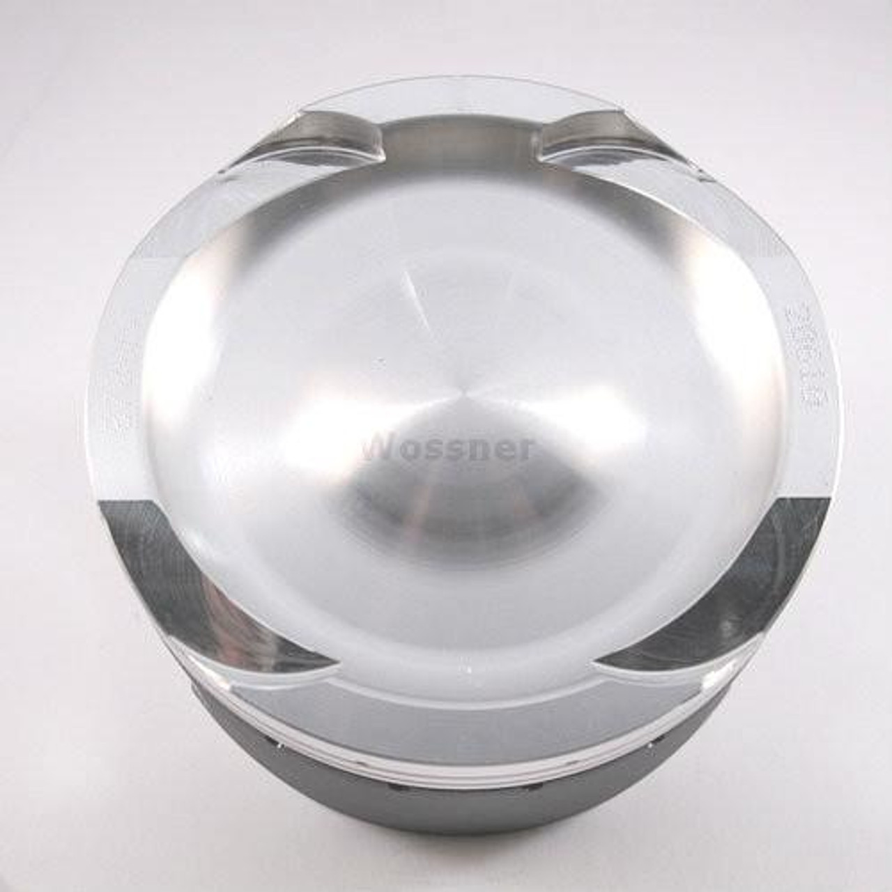 Wossner Piston Kit Kawasaki ZX14R (06-26), close-up view of a shiny, metallic piston with a smooth surface and engraved details.