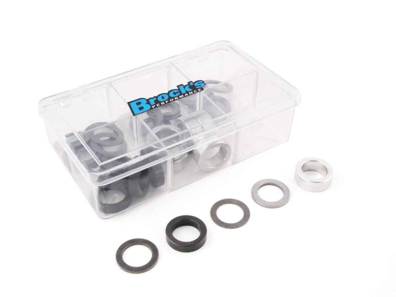 Brocks Performance Brocks Clutch Spring Shim Kit, transparent plastic storage box with metal and rubber clutch shims inside and a few individual shims laid out outside the box.