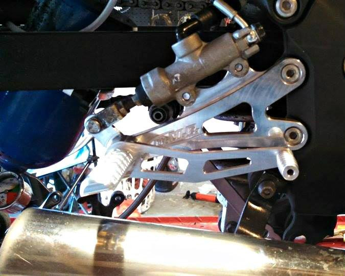 DME Rear Sets for Kawasaki ZX14R (06-25), motorcycle rear foot pegs and foot controls installed on the bike's frame.