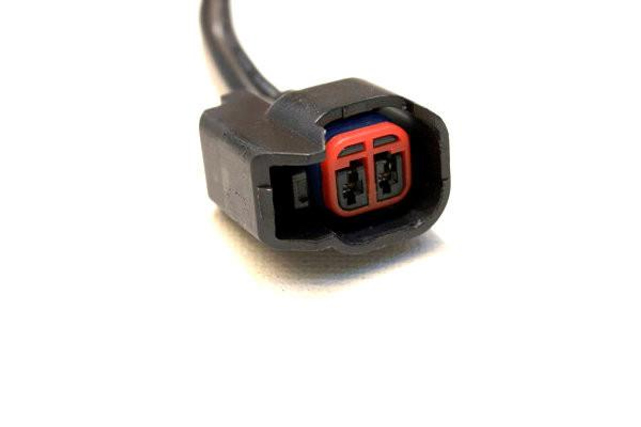 Schnitz Racing Fuel Injector Kit for Kawasaki ZX14R and ZX10R, close-up of the black and red electrical connector for Yamaha motorcycle fuel injectors. Schnitz Racing Fuel Injector Kit for Kawasaki ZX14R and ZX10R, close-up of the black and red electrical connector for Yamaha motorcycle fuel injectors.