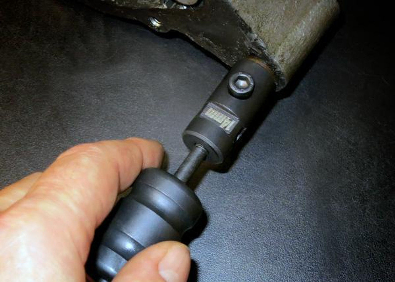 Motion Pro Dowel Pin Puller Set, hand using the tool to remove a dowel pin from a metal component. Motion Pro Dowel Pin Puller Set, hand using the tool to remove a dowel pin from a metal component.