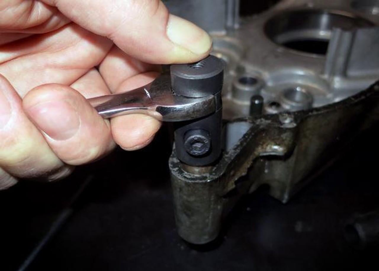 Motion Pro Dowel Pin Puller Set, hand using a ratchet wrench to remove a dowel pin from machinery part. Motion Pro Dowel Pin Puller Set, hand using a ratchet wrench to remove a dowel pin from machinery part.