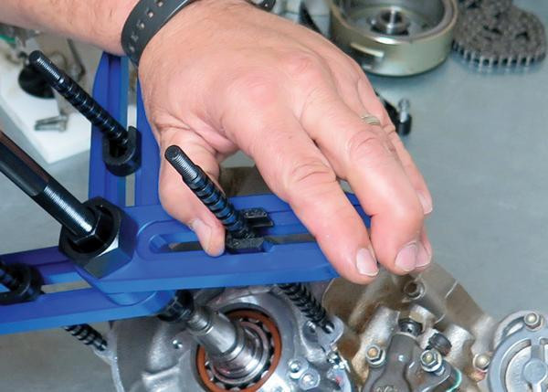 Motion Pro Crankcase Splitter V2, person using the splitters to separate engine crankcase halves.