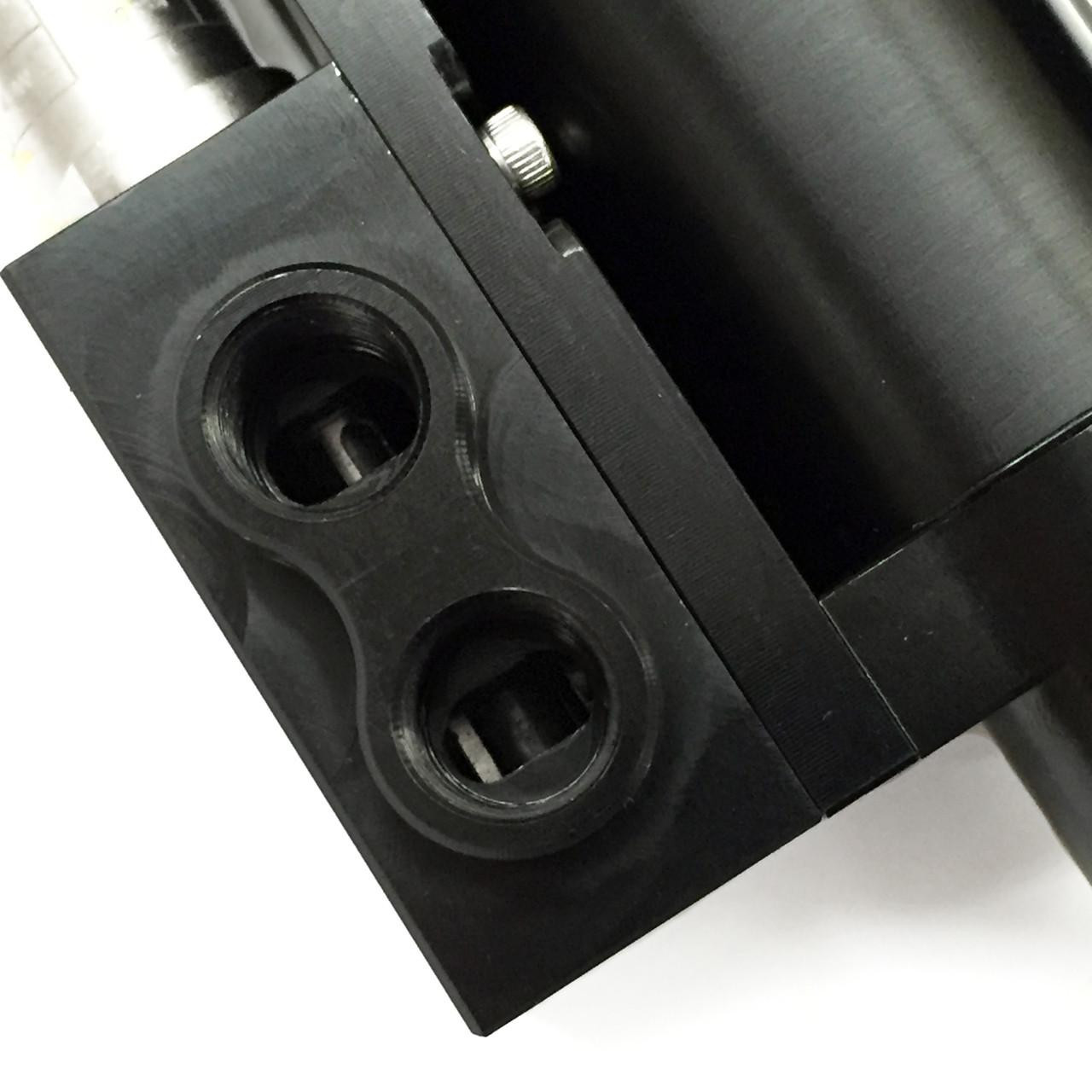 Ryan Schnitz Racing RSR Direct Shift Air Cylinder Assembly, close-up view of the black mechanical air cylinder with two port openings for connections.