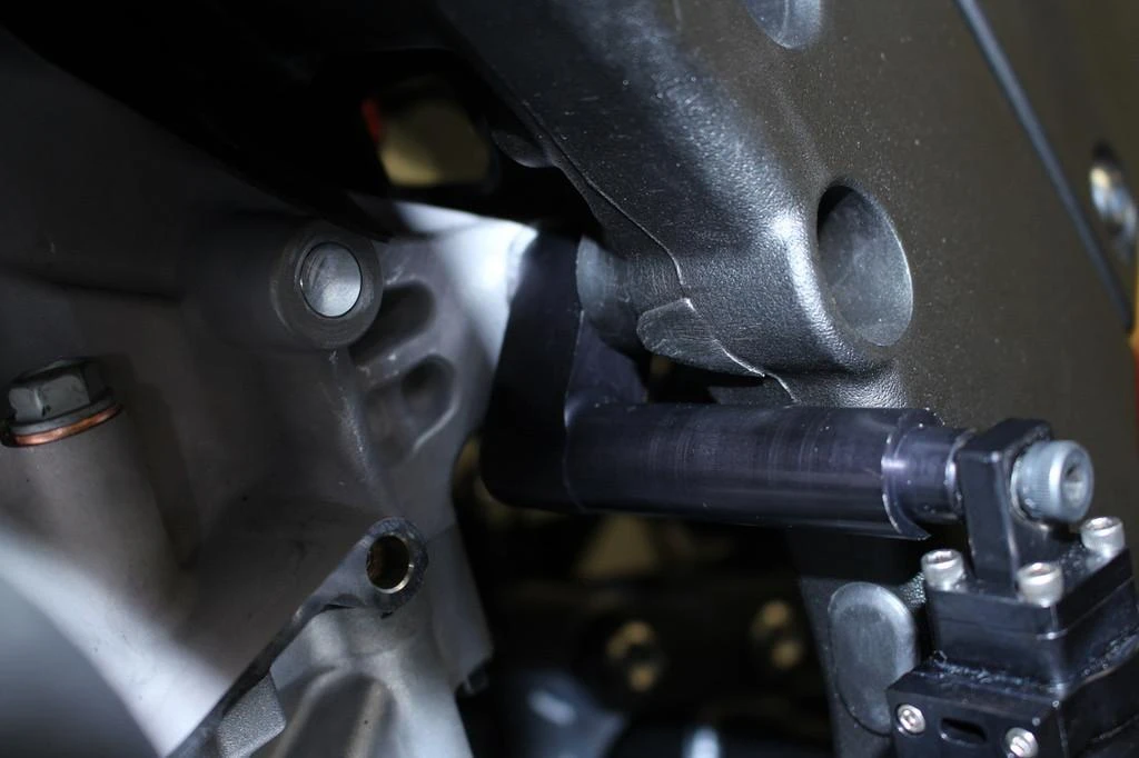 HTP Performance HTP Air Shifter Bracket Kawasaki ZX-10R (16-20), close-up of motorcycle air shift bracket mounted on engine for racing performance.