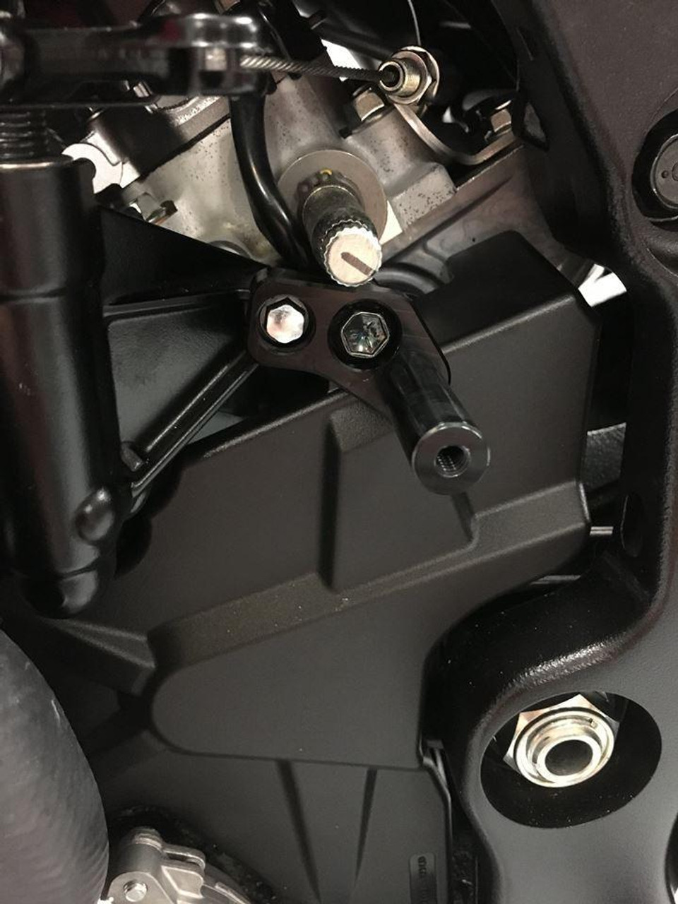 HTP Performance HTP Air Shifter Bracket Suzuki GSXR1000 (17-25), close-up of the black motorcycle air shifter bracket mounted to the motorcycle frame near the engine. HTP Performance HTP Air Shifter Bracket Suzuki GSXR1000 (17-25), close-up of the black motorcycle air shifter bracket mounted to the motorcycle frame near the engine.