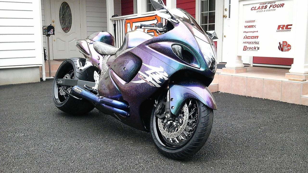 Brocks Performance Brocks Tiwinder Full Exhaust Street Baffle Blue Suzuki Hayabusa (99-26), motorcycle with a custom iridescent paint job and aftermarket exhaust system parked outside a house.
