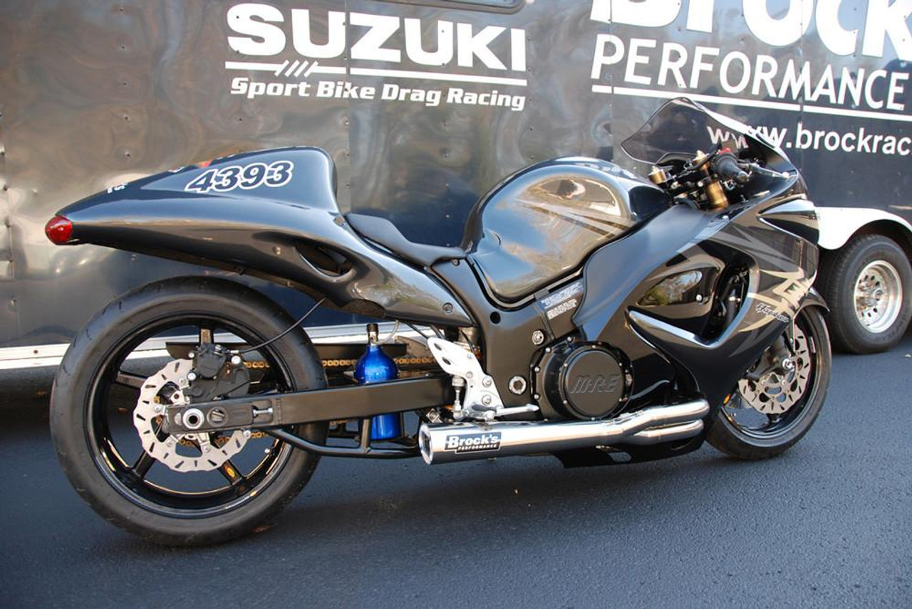 Brocks Performance Brocks Tiwinder Full Exhaust Race Baffle Suzuki Hayabusa (99-26), black motorcycle with custom exhaust system and racing decals parked in front of a Brock Racing trailer. Brocks Performance Brocks Tiwinder Full Exhaust Race Baffle Suzuki Hayabusa (99-26), black motorcycle with custom exhaust system and racing decals parked in front of a Brock Racing trailer.