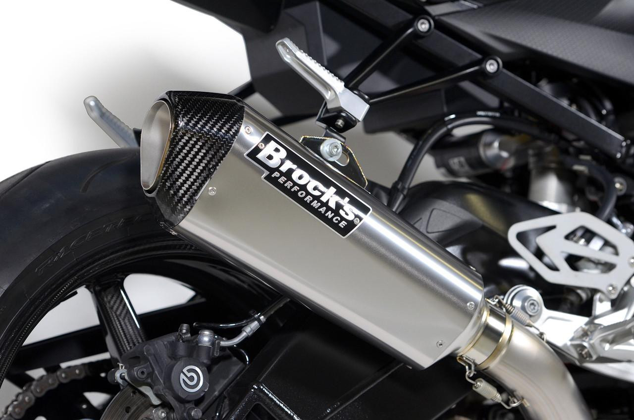 Brocks Performance Brocks CT Single Full Exhaust 16" QuietKore Muffler for BMW S1000RR 2015-2019 and S1000R 2017-2020, close-up view of the motorcycle's exhaust system with a carbon fiber tip and sleek metallic body.