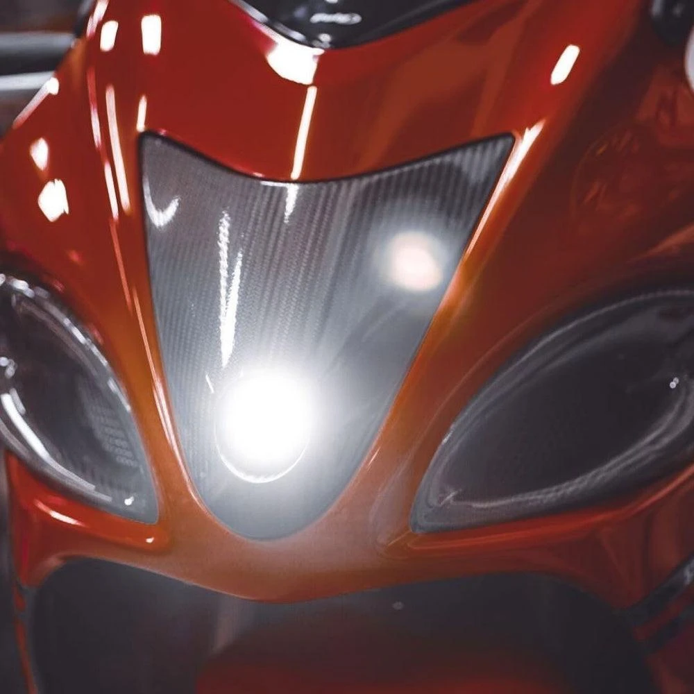 Montgomery Motorsports Carbon Fiber Headlight Insert Suzuki Hayabusa (08-20), close-up of motorcycle's front with carbon fiber headlight insert, sleek orange bodywork, and black accents.