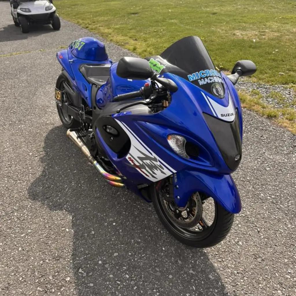 Montgomery Motorsports Carbon Fiber Motorcycle Parts Carbon Fiber Headlight Insert Suzuki Hayabusa (08-20), close-up view of a blue Suzuki Hayabusa motorcycle with carbon fiber headlight insert.