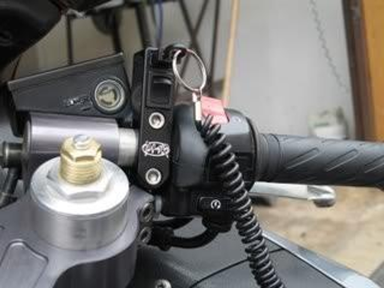 PMR Components PMR Easy Mount Stealth Tether Kill Switch w/Toggle, close-up view of the black kill switch with toggle and tether attachment mounted on a motorcycle handlebar.