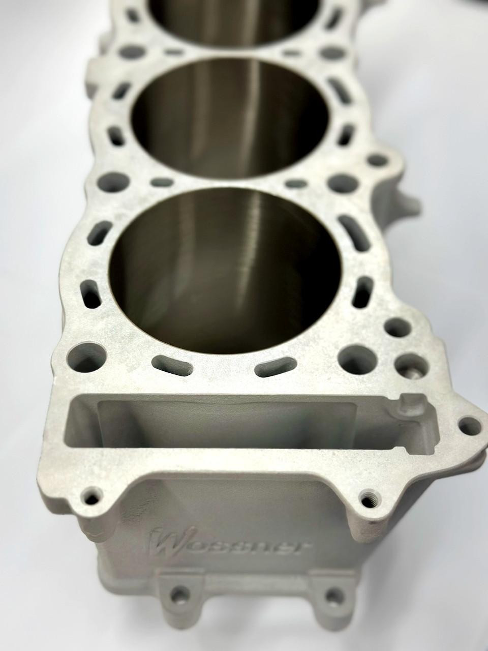 Wossner Cylinder Block Suzuki Hayabusa (99-26), aluminum engine cylinder block with machined holes for pistons, high-performance motorcycle engine component. Wossner Cylinder Block Suzuki Hayabusa (99-26), aluminum engine cylinder block with machined holes for pistons, high-performance motorcycle engine component.