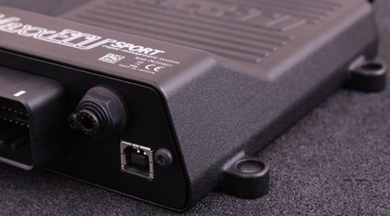MaxxECU Sport Engine Control Unit, close-up of the sleek black device with connectivity ports and branding. MaxxECU Sport Engine Control Unit, close-up of the sleek black device with connectivity ports and branding.