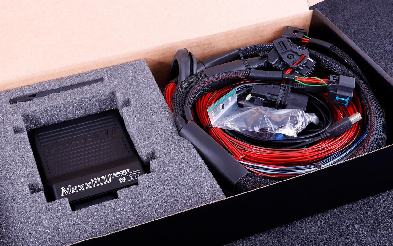 MaxxECU Sport Engine Control Unit, automotive electronic control module with wiring harness and connectors, in packaging foam and box. MaxxECU Sport Engine Control Unit, automotive electronic control module with wiring harness and connectors, in packaging foam and box.