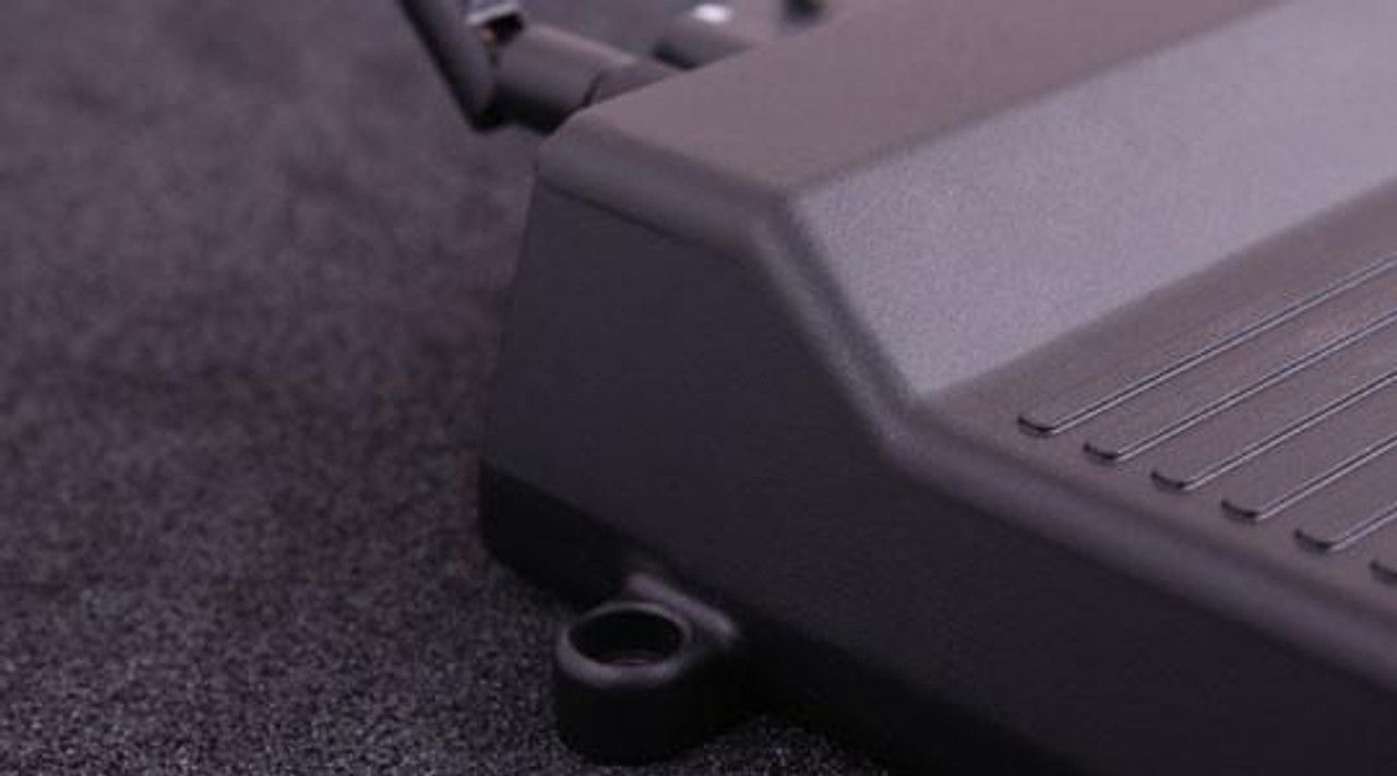 MaxxECU Race Engine Control Unit, close-up view of the control unit on a dark surface showing its sleek design and mounting point.