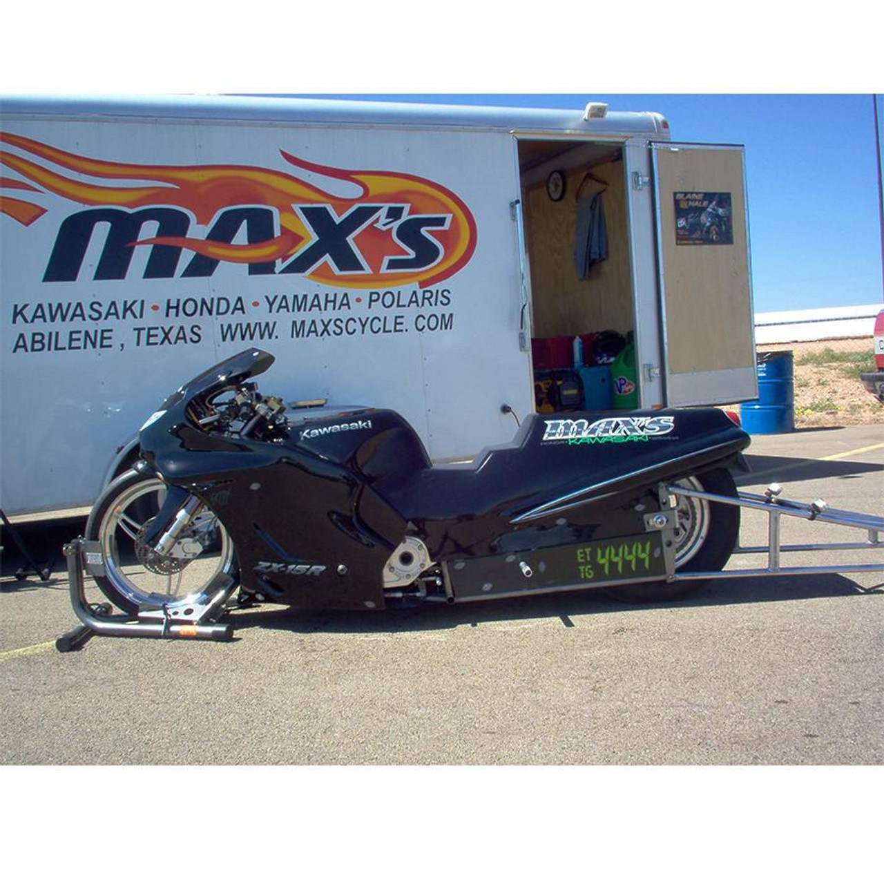 Baxley Drag Chock, a black motorcycle drag racing chock with a digital timer attached, used to secure a motorcycle during racing events.
