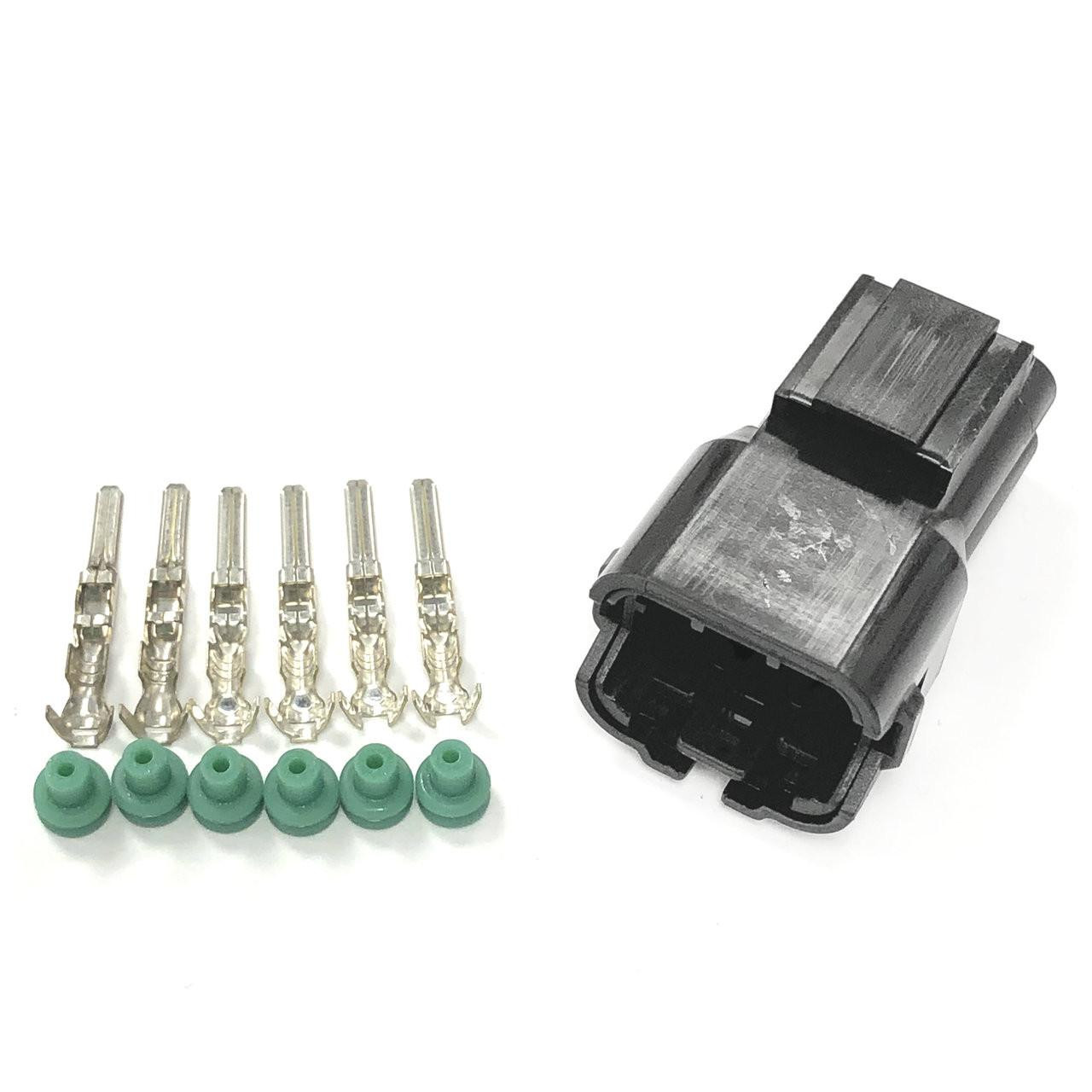 Ryan Schnitz Racing RSR Connector Kit, 6 Way Pin HM, close-up view of the black plastic connector with six metal pins and green rubber seals, automotive electrical component. Ryan Schnitz Racing RSR Connector Kit, 6 Way Pin HM, close-up view of the black plastic connector with six metal pins and green rubber seals, automotive electrical component.