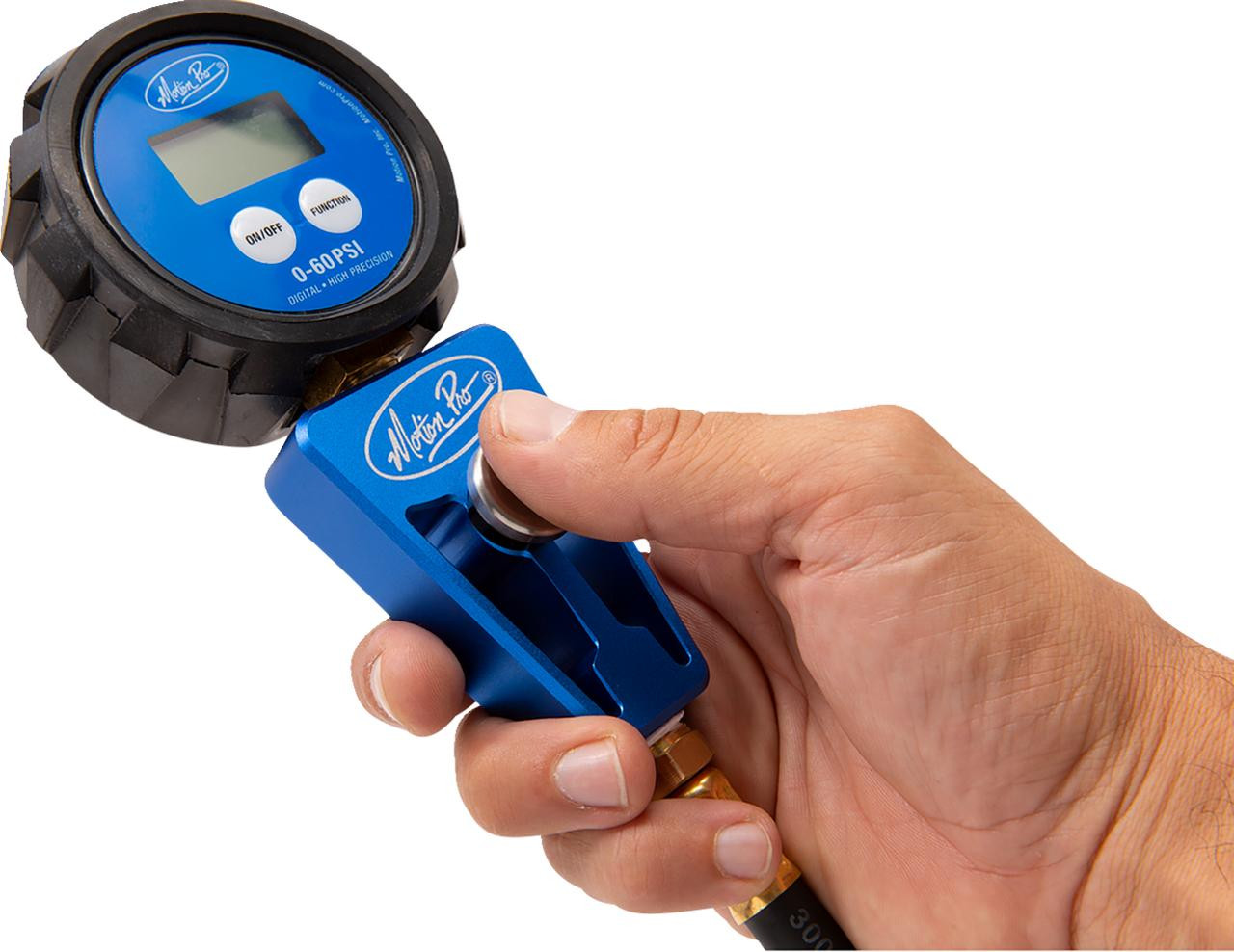 Motion Pro Digital Tire Pressure Gauge 0-60 psi, handheld tire pressure gauge being used to measure tire pressure