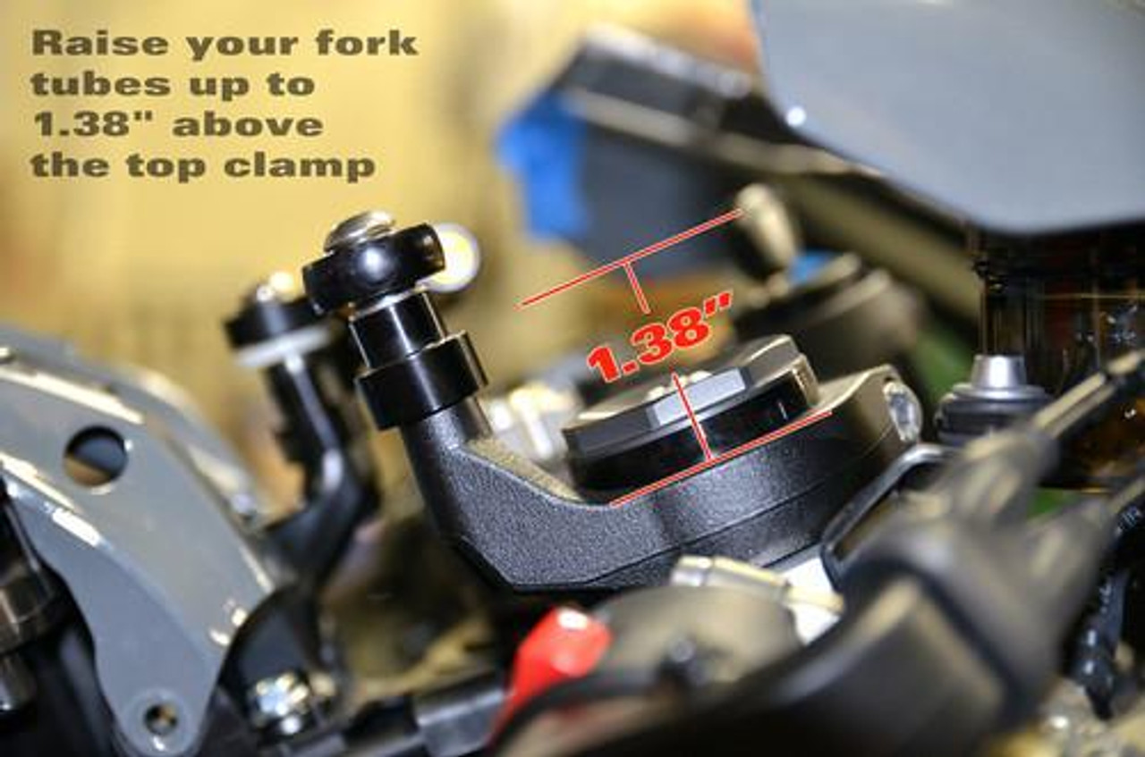 Brocks Performance Brocks Steering Damper Riser Kit Kawasaki ZX10R (16-21), close-up view of the riser kit installed on the motorcycle's steering damper with measurements indicating 1.38 inches elevation above the top clamp. Brocks Performance Brocks Steering Damper Riser Kit Kawasaki ZX10R (16-21), close-up view of the riser kit installed on the motorcycle's steering damper with measurements indicating 1.38 inches elevation above the top clamp.