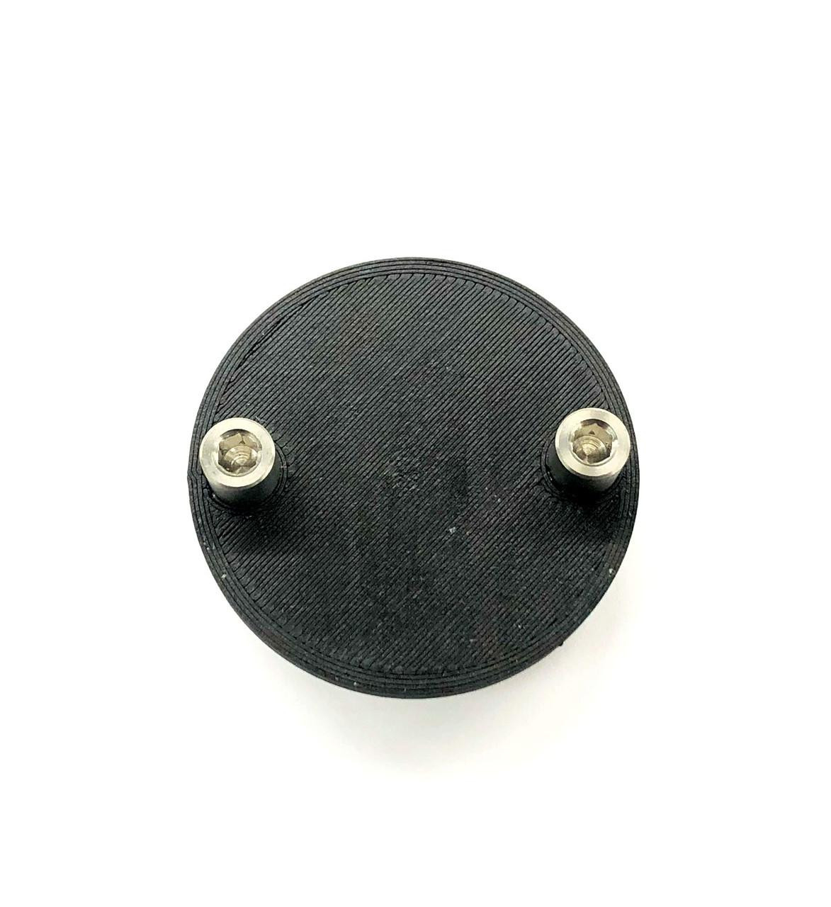 Ryan Schnitz Racing Oil Pump Priming Tool, Suzuki GSXR1000 (01-08), image showing the black circular tool with two metal screw fittings on the top surface. Ryan Schnitz Racing Oil Pump Priming Tool, Suzuki GSXR1000 (01-08), image showing the black circular tool with two metal screw fittings on the top surface.