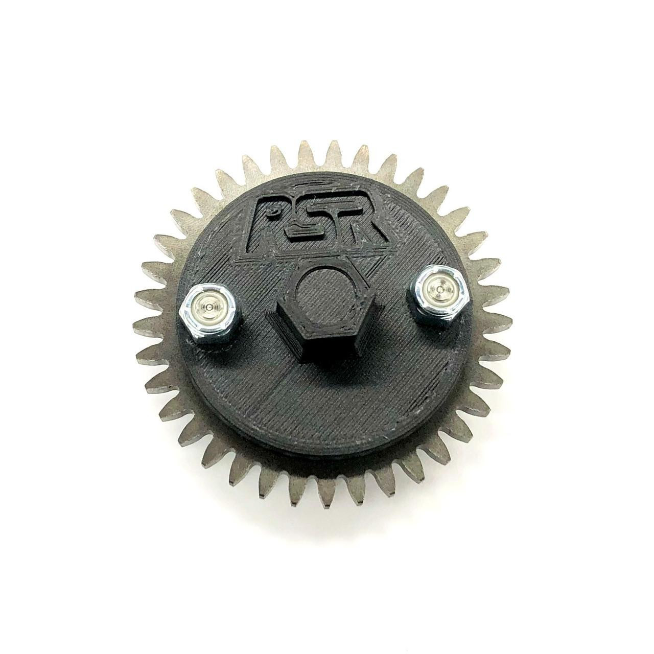 Ryan Schnitz Racing Oil Pump Priming Tool, Suzuki GSXR1000 engine oil pump priming tool with black plastic housing, metal gear, and two attached screws for motorcycle maintenance. Ryan Schnitz Racing Oil Pump Priming Tool, Suzuki GSXR1000 engine oil pump priming tool with black plastic housing, metal gear, and two attached screws for motorcycle maintenance.