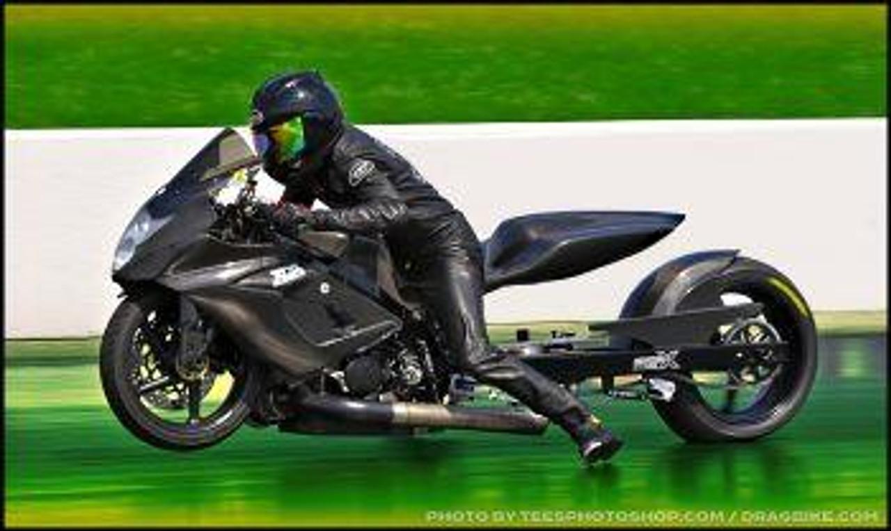 DME Air Ram Chain Tensioner Kit, motorcycle rider in black riding gear on a black racing motorcycle on the track.