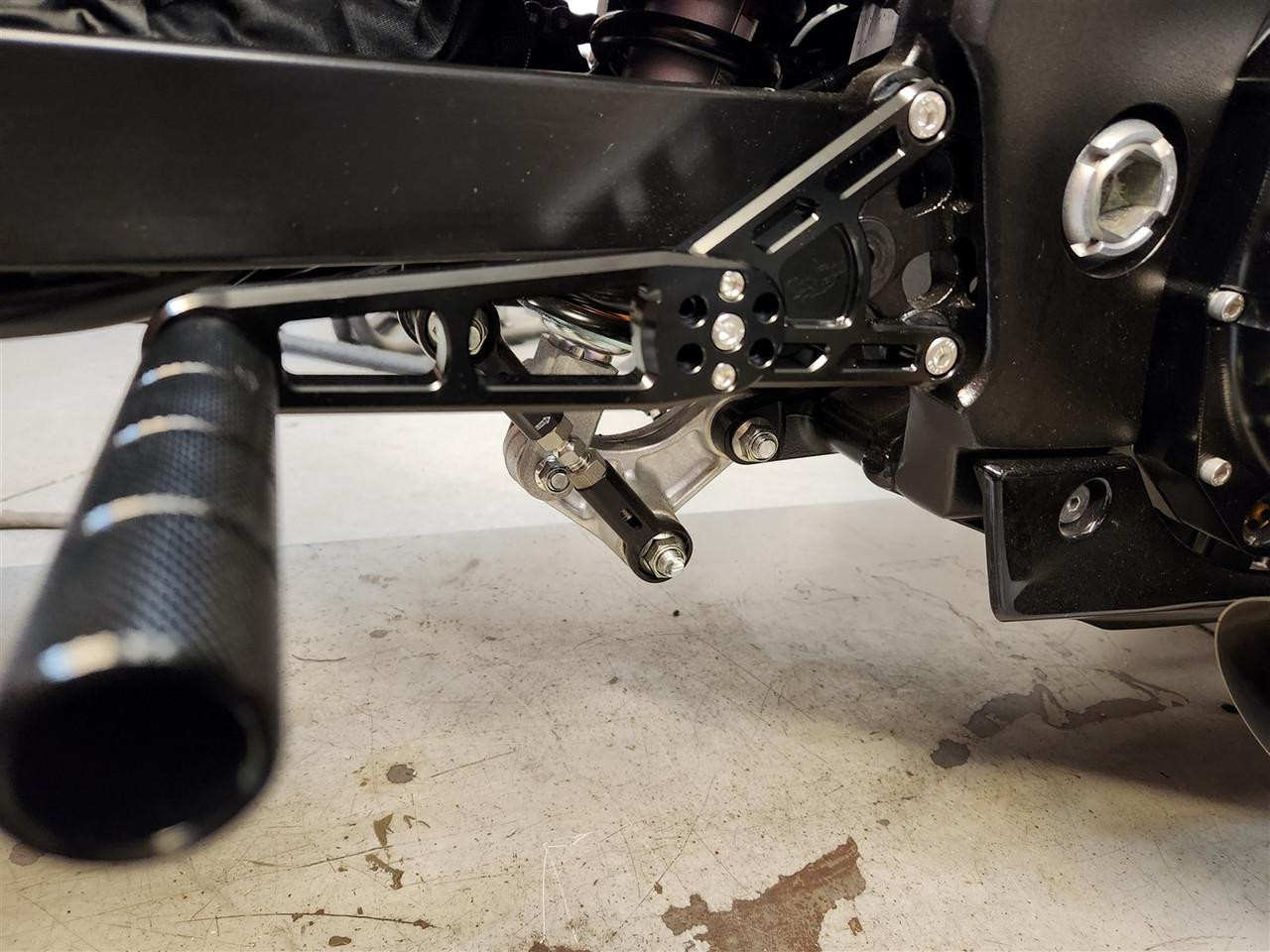 VooDoo Voodoo Rearsets, Grudge, Suzuki Hayabusa (99-25), close-up view of black motorcycle rearsets with footpegs and mounting hardware.