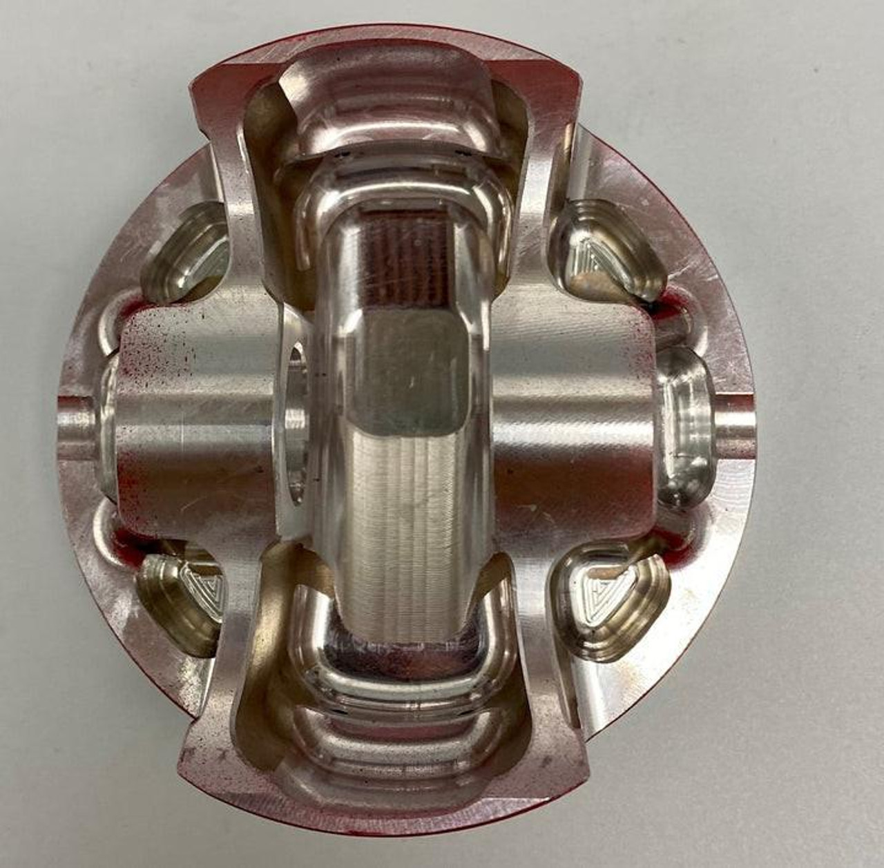 Wossner Piston Kit Suzuki GSXR1000 (17-25), top view of high-performance motorcycle piston with precision-machined metal components. Wossner Piston Kit Suzuki GSXR1000 (17-25), top view of high-performance motorcycle piston with precision-machined metal components.