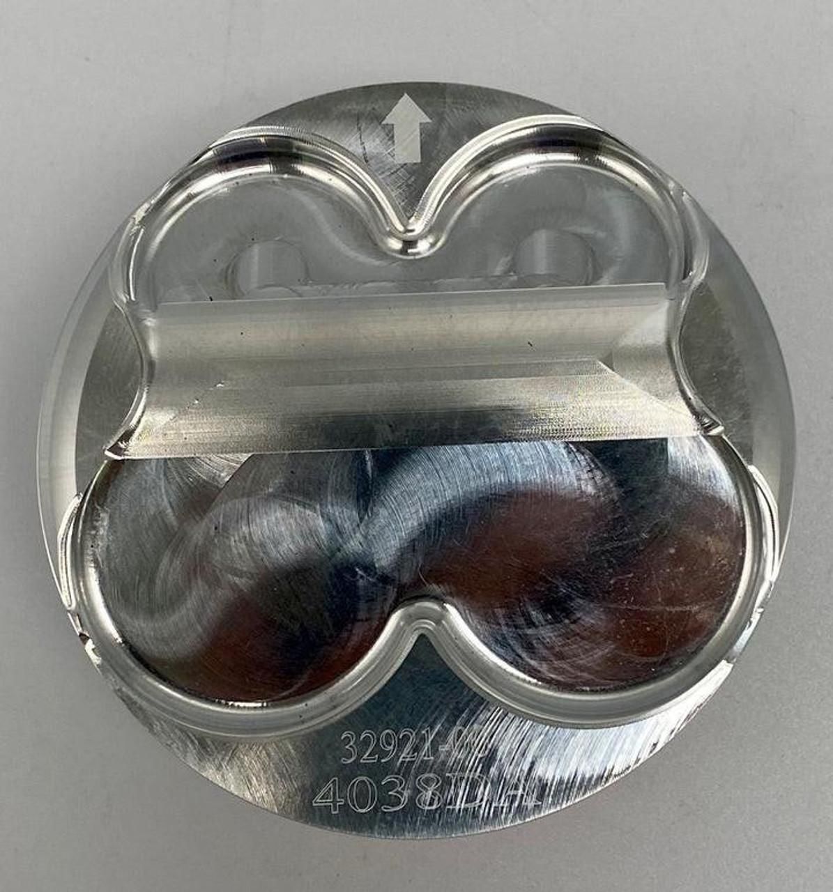 Wossner Piston Kit Suzuki GSXR1000 (17-25), aluminum piston components with clear protective covering, viewed from the top. Wossner Piston Kit Suzuki GSXR1000 (17-25), aluminum piston components with clear protective covering, viewed from the top.