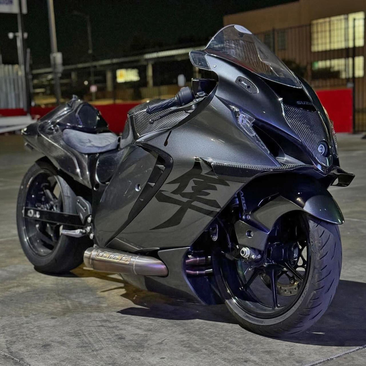 Montgomery Motorsports Carbon Fiber Headlight Insert Suzuki Hayabusa (22-25), close-up of black carbon fiber headlight insert on a sleek Suzuki Hayabusa motorcycle.