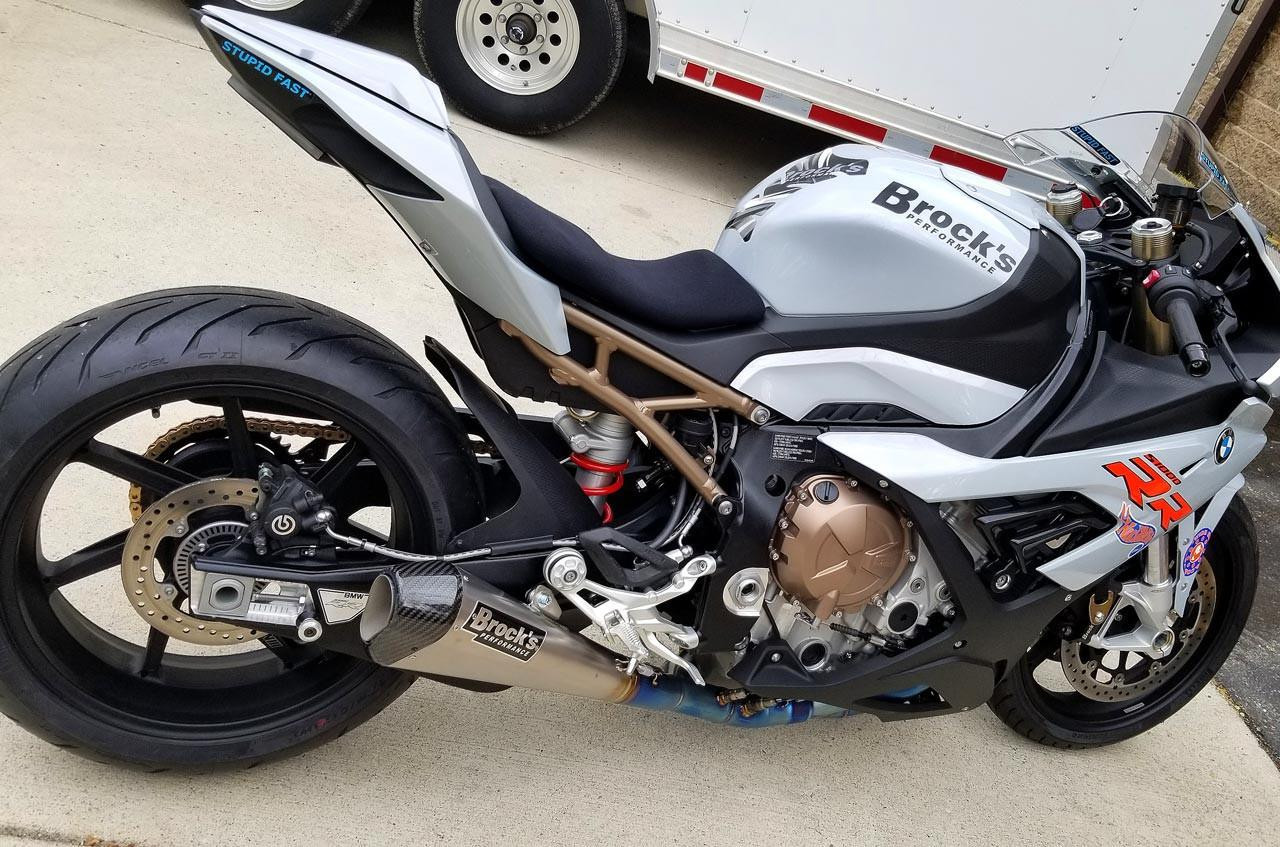 Brocks Performance Brocks CT Megaphone Full System with 17-inch Muffler on a BMW S1000RR motorcycle, showcasing a sleek motorcycle exhaust system with branding and a distinctive golden muffler.
