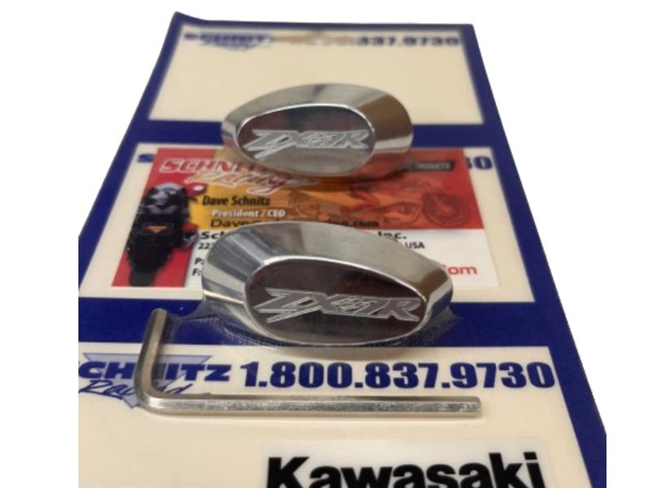 Polished Mirror Block Off Plates Kawasaki ZX7 (91-96), two chrome plated block off plates with Kawasaki ZXR logo engraved, and an Allen wrench for installation displayed on Kawasaki service parts box. Polished Mirror Block Off Plates Kawasaki ZX7 (91-96), two chrome plated block off plates with Kawasaki ZXR logo engraved, and an Allen wrench for installation displayed on Kawasaki service parts box.