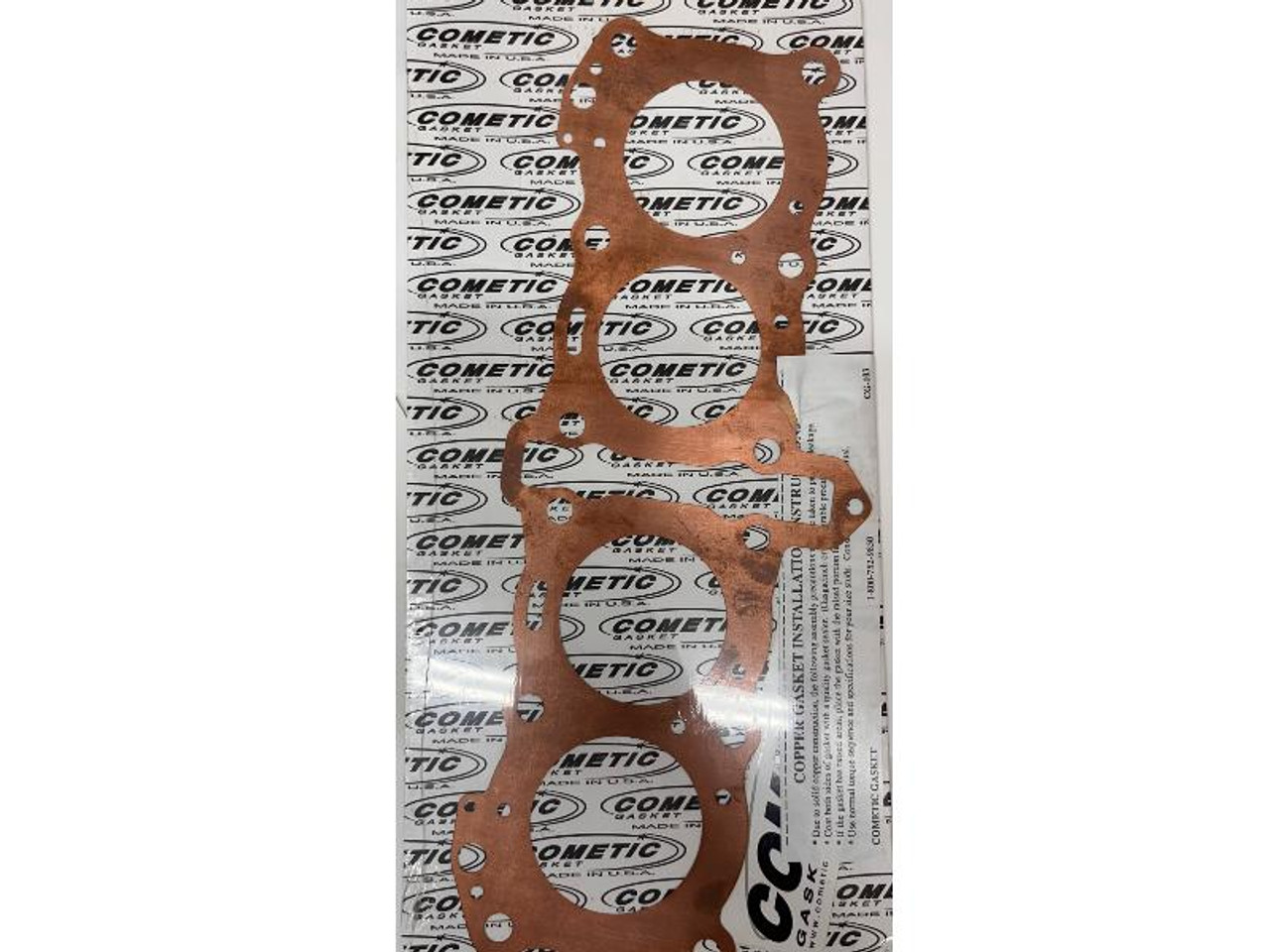 Cometic Head Gasket Suzuki GSXR750, a copper-colored gasket for motorcycle engine sealing. Cometic Head Gasket Suzuki GSXR750, a copper-colored gasket for motorcycle engine sealing.