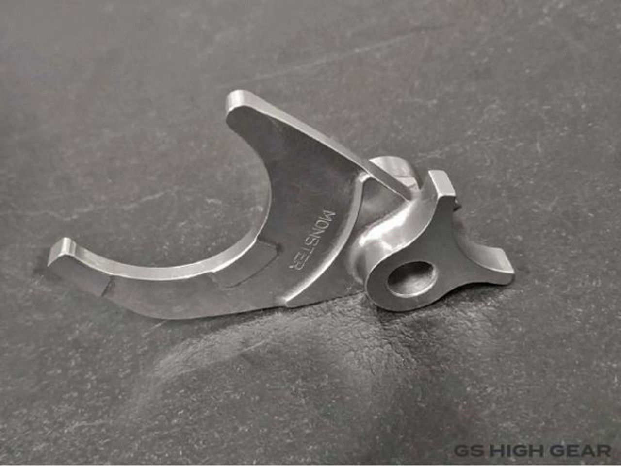 Monster Race Products Billet Shift Fork Suzuki GS1100/1150, a high-performance silver metal motorcycle shift fork with a precise design for Suzuki GS1100 and GS1150 models.