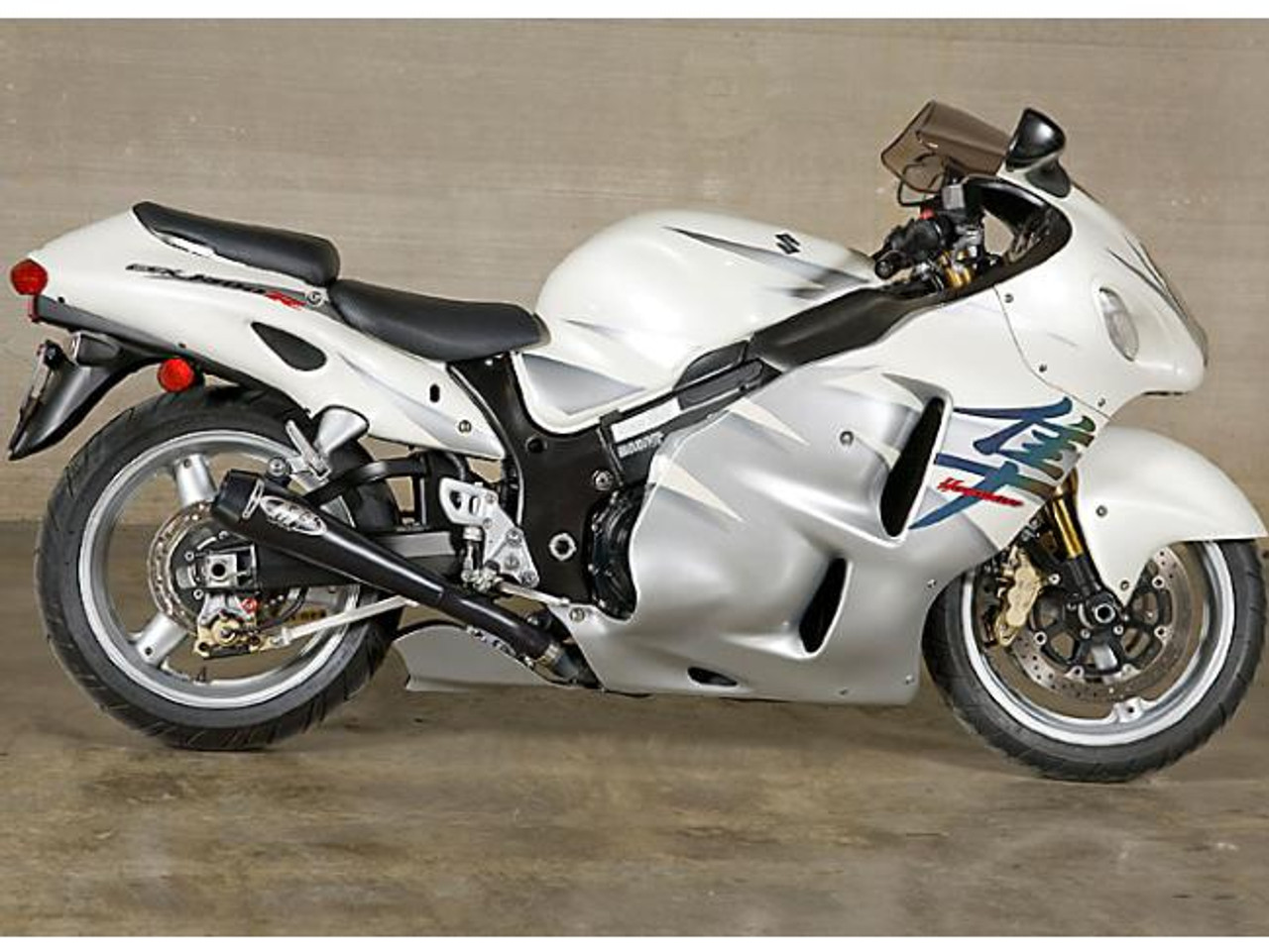 M4 Performance Exhausts M4 Dual Black Retro-Drag Slip Ons Suzuki Hayabusa (99-07), black exhaust slip ons installed on a silver Suzuki Hayabusa motorcycle.